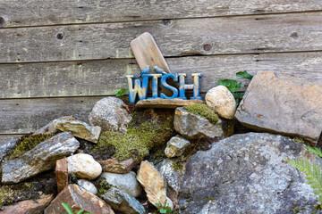 Make a wish sign mounted on top of rocks