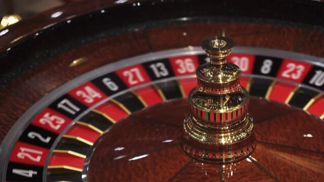 Roulette wheel in casino and ball on zero number, lose or bad luck concept, closeup view