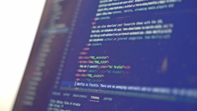 Website source code being scrolled through the computer monitor
