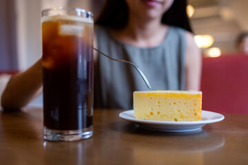 Woman enjoy her cake in coffee shop