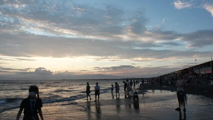FUJISAWA, KANAGAWA, JAPAN - AUGUST 2022 : View of Enoshima beach (sea) at Shonan area in sunset. Time lapse shot, dusk to night. Japanese hot summer holiday (vacation) season concept video.