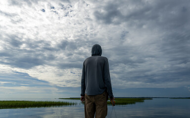 Fototapeta premium Silhouette of a Man Fishing on a Boat 