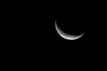 Obraz na płótnie Canvas Close up of the Wanning Crescent Moon taken with a telephoto lens at 600mm with 2x extender for a total of 1200mm.