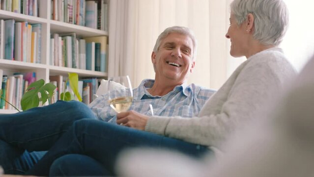 Retirement, relax and wine with couple in living room and toast together for marriage, happiness and milestone. Lounge, white wine and happy with senior married man and woman sitting on sofa