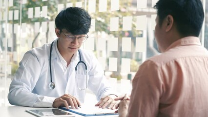 Doctor shaking hands with older patient in the clinic room.