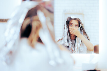 Woman Looking at Herself in the Mirror Waiting for Hair Transformation. Girl changing her mind about hairstyle in the middle of the process
