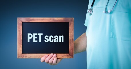 PET scan (Positron emission tomography). Doctor shows sign/board with wooden frame. Background blue