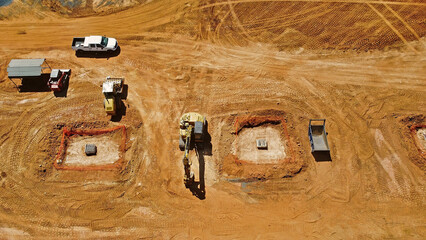 overhead view of excavator, bulldozer, and truck on grading job site