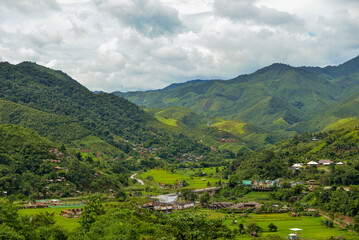 Village in the middle of the valley in the midst of nature during the rainy season. Sapan Village, Nan Thailand