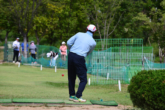 Korean elderly man and woman are enjoying park golf at Sancheong Park Golf Course.