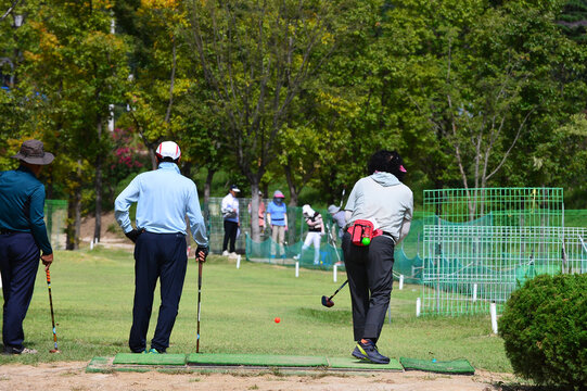 Korean elderly man and woman are enjoying park golf at Sancheong Park Golf Course.