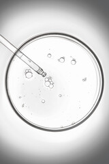 Petri dish with pipette in a black and white colored.
