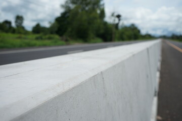 concrete barrier To prevent cars crossing the lane to collide (blurred image)