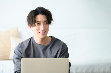 Handsome man playing computer