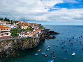 Fototapeta premium Madeira. Camara de Lobos Aerial View. Small fisherman village with many small boats in a bay. Madeira Island, Portugal.