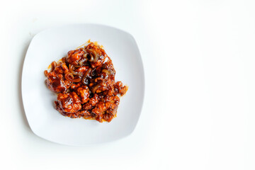 Butter sauce chicken with onions on white plate isolated on white background