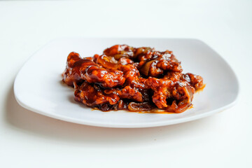 Butter sauce chicken with onions on white plate isolated on white background