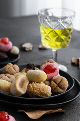 Assortment of Panellets, different Catalan small cakes, served with sweet white wine  for All Saints Day, Dia Todos Los Santos in Catalonia, Spain.