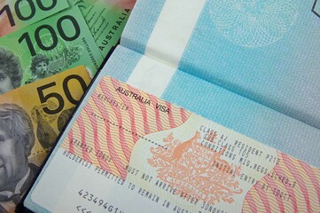 open passport with australian resident visa and australian bank notes 