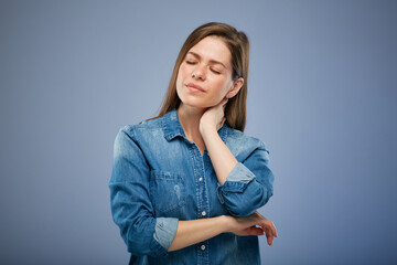 Woman with headache and eyes closed touching her face. isolated portrait on blue background.