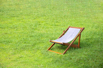 Sunbed deckchairs on grass, place for relax.