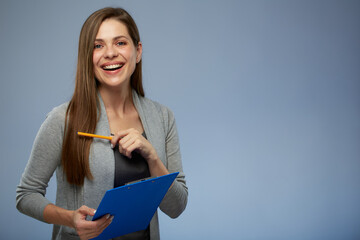Smiling woman teacher holding blue clipboard and ready administer exam. Isolated portrait.