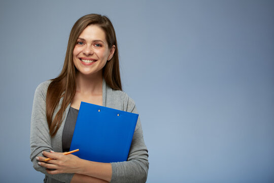 Smiling woman teacher holding blue clipboard and ready administer exam. Isolated portrait.