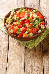 Turkish salad kozlenmis patlıcan salatası tarifi with grilled eggplant, baked peppers, onions, tomatoes and garlic close-up in a bowl on the table. Vertical