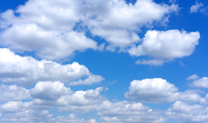 Clear blue sky background with white clouds