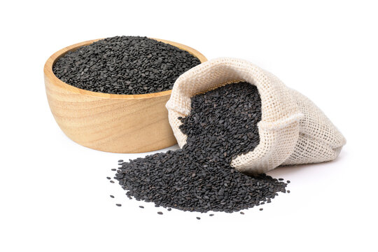 Black sesame seeds in sack bag and wooden bowl isolated on white background.