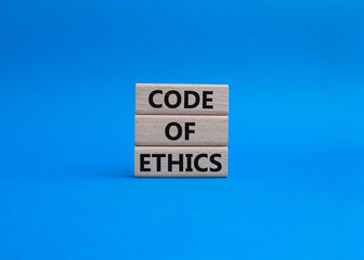 Code of ethics symbol. Concept words Code of ethics on wooden blocks. Beautiful blue background. Business and Code of ethics concept. Copy space.