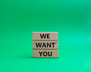 We want you symbol. Concept words We want you on wooden blocks. Beautiful green background. Business and We want you concept. Copy space.