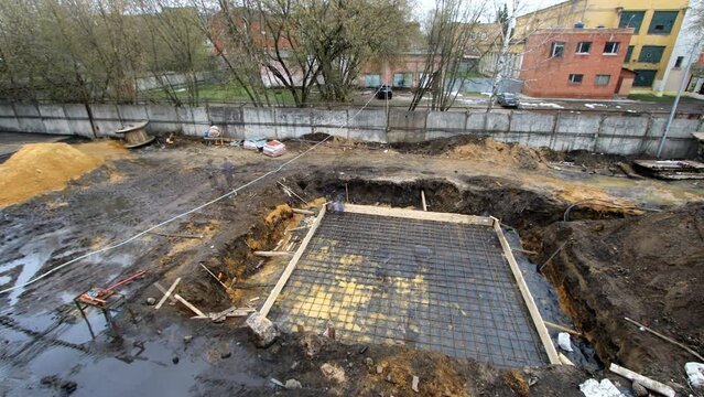 Laying foundation and building small construction on city street time lapse. Using machines to install and assemble house from winter till summer