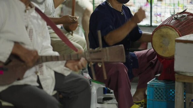 A static shot of a band where band members are seen playing different instruments to entertain people 