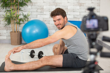 merry glad sport blogger smiling while stretching leg