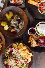 Vertical restaurant food on table. Vegetables and jalapeno pepper, mushrooms with roast grill chicken, stir fried potato