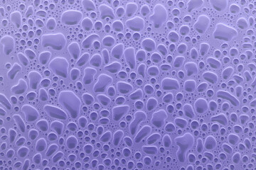 Colorful abstract pattern of round bubbles or droplets as cells in soft light violet or very peri...