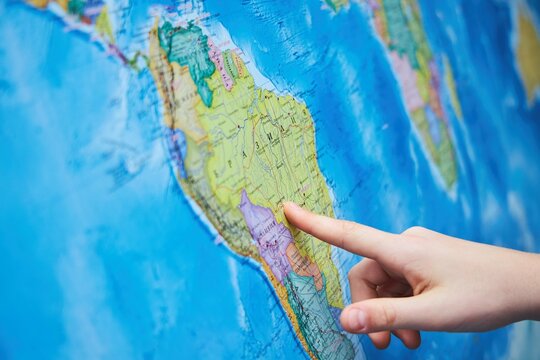 Topographic map in Russian and a finger pointing to a large city.