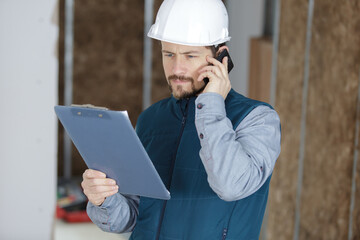 man with clipboard and smartphone