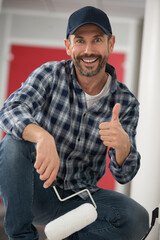 smiling professional painter in dungarees giving a thumbs up © auremar