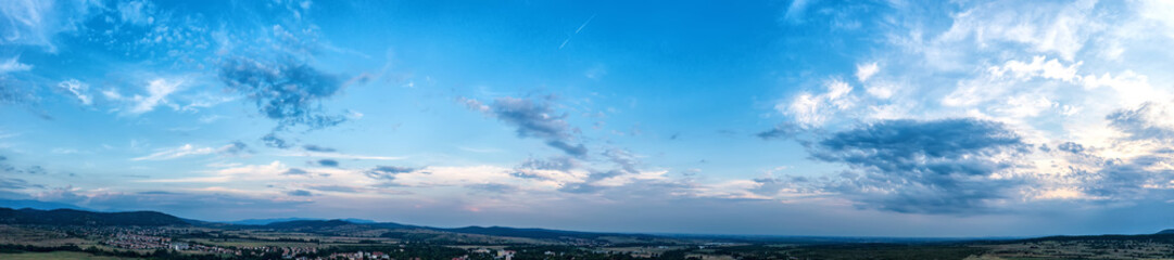 Obraz premium Banner view of blue sky with fluffy clouds after sunset over the land