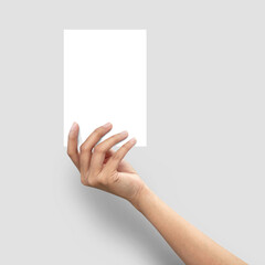 Close up of  woman hand holding blank paper sheet A5 size on grey background.