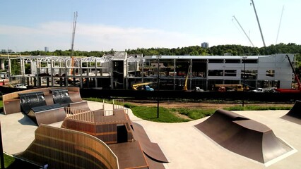 Assembling of large building near skating ramp in city park time lapse. Urban architectural object for public events during weeks