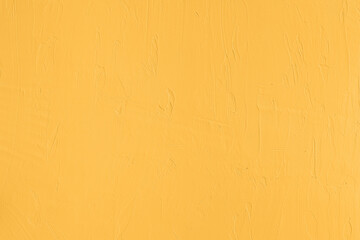 Saturated pastel yellow colored low contrast Concrete textured background. Empty colourful wall texture with copy space for text overlay and mockups. 2023, 2024 color trend