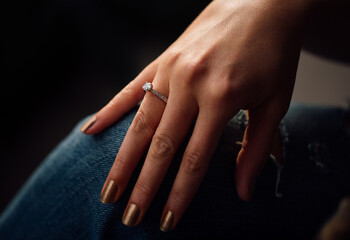 Woman hand with diamond wedding ring 