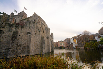 Gravensteen , medieval castle near leie river in old town of ghent dunring winter evening : Ghent ,...