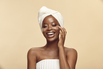 Afro-american woman with ideal skin applying collagen eye patches mask.