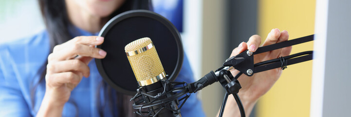 Radio presenter works adjusts microphone, prepares speak before recording podcast, and lives on...