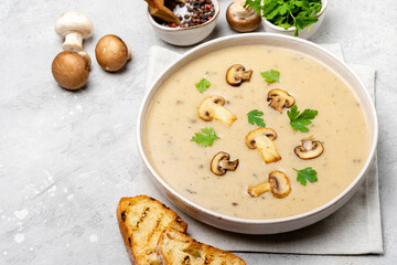 Mushroom soup with bread and fresh mushrooms, autumn seasonal cream soup with vegetables