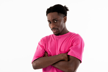 Portrait of afrcan american young guy looking at camera standing in the middle of white background in studio isolated posing showing angry furious emotions wearing pink sportcostume.Man with funny - Powered by Adobe